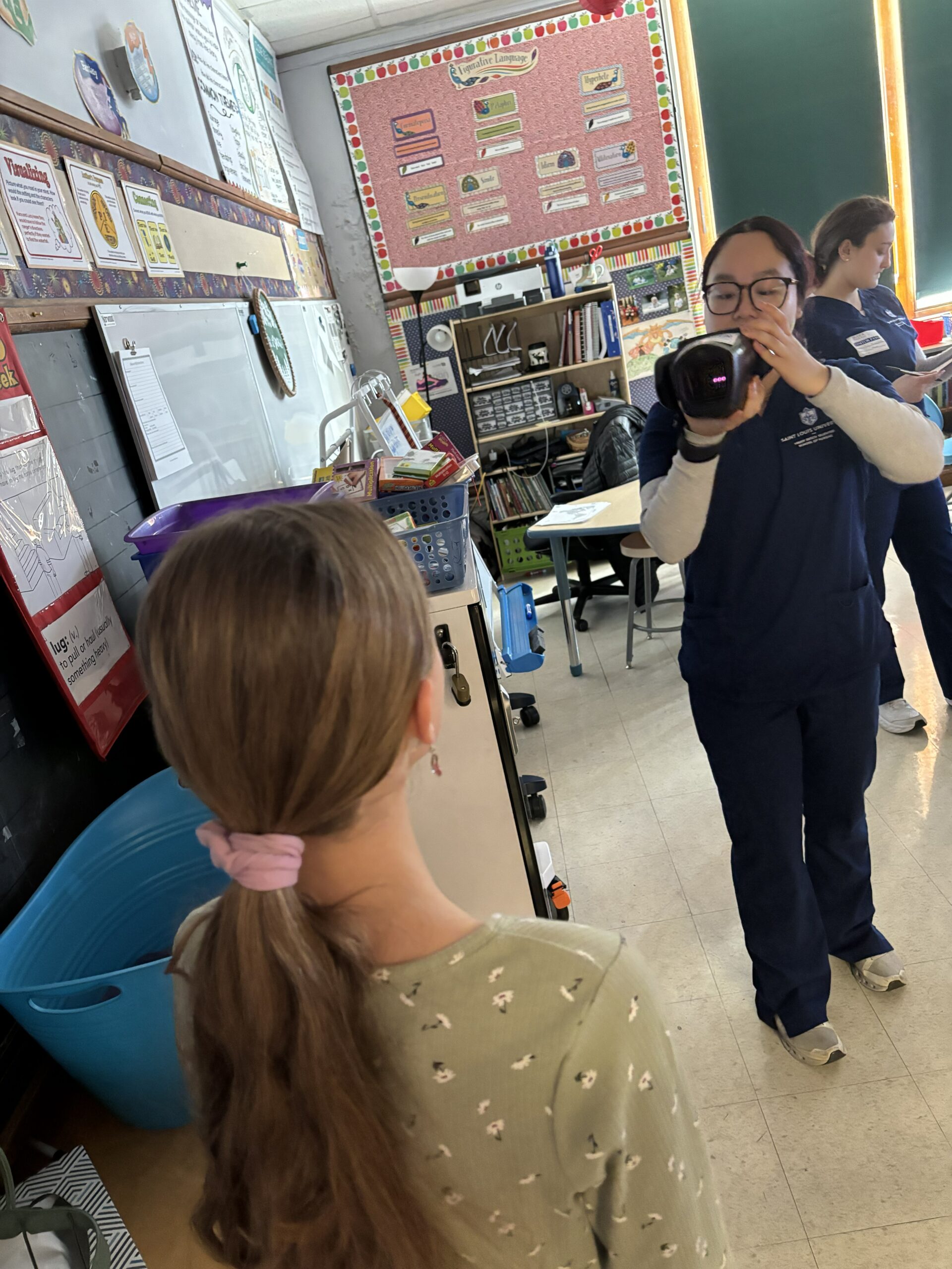 A KVFL team member screening a student's vision at school